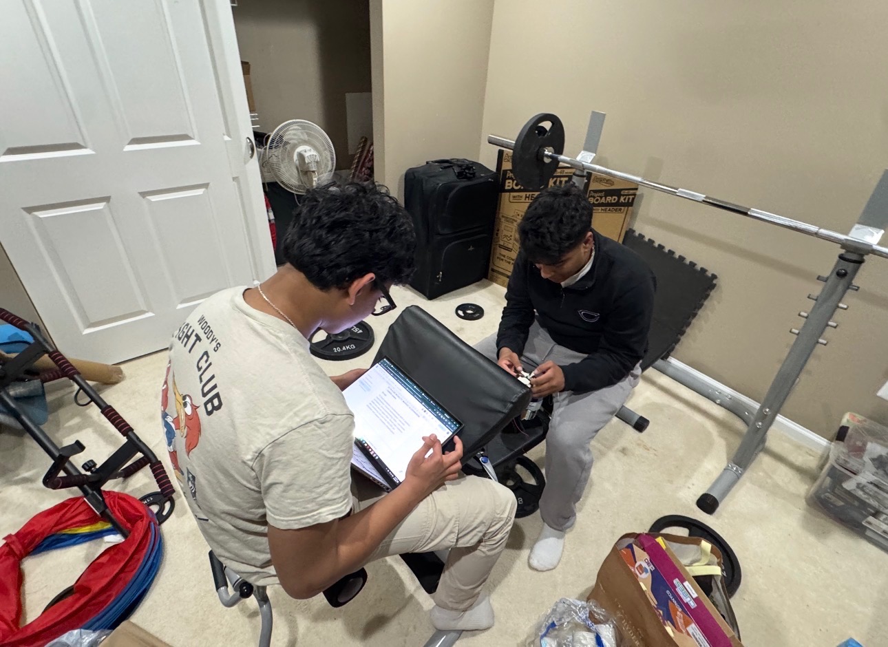 Tanish and Hatim working post-weightlifting session on scripts and prototype wiring